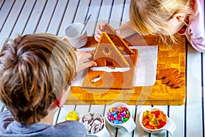 Familiy building a sweet ginger bread house