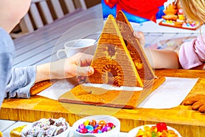 Familiy building a sweet ginger bread house