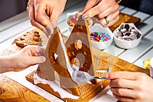 Familiy building a sweet ginger bread house