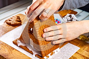 Familiy building a sweet ginger bread house