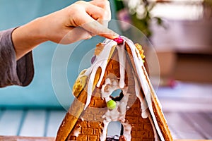 Familiy building a sweet ginger bread house