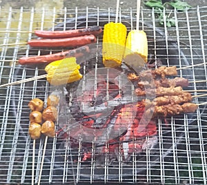 Familiy time,, sate, grilled sausage, grilled corn and grilled meatballs