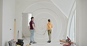 The family is actively involved in repair, painting the walls white and taking measurements. Family bonding during a DIY