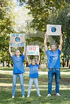 Family of activists holding placards with