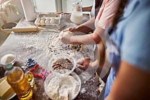 Family activity of making dough in the kitchen