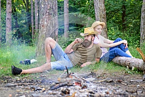 Family activity for summer vacation in forest and nature. Couple relaxing after gathering mushrooms in wild for food