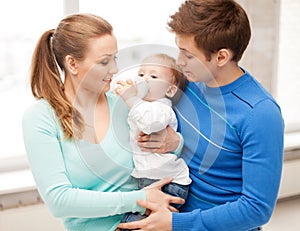 Family and adorable baby with feeding-bottle