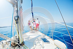 Family with adorable kids resting on yacht