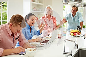 Family With Adult Children Having Argument At Breakfast