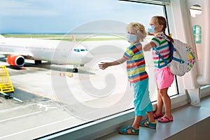 Family in airport in face mask. Virus outbreak