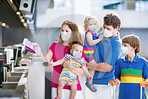 Family in airport in face mask. Virus outbreak photo
