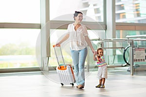 Family in airport. Kids fly. Travel with child