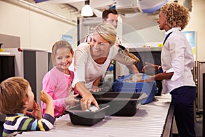 Family At Airport Passing Through Security Check