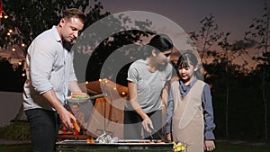 Family all together camping in garden, old couple cooking BBQ. Divergence.