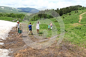 Family on alpine meadow of Lago-Naki plateau