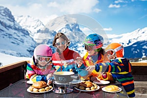 Family apres ski lunch in mountains. Skiing fun photo