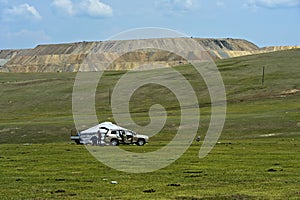 Family arriving by car at its yurt