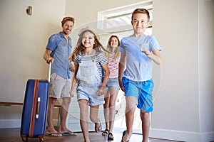 Family Arriving At Summer Vacation Rental photo