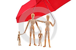 Family of articulated wooden dummies protected by an umbrella