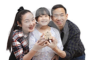 Family Asian happy hand holding mini wood house model from model on wood table, Planning buy Real Estate, Planning to buy property
