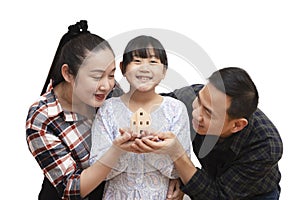 Family Asian happy hand holding mini wood house model from model on wood table, Planning buy Real Estate, Planning to buy property