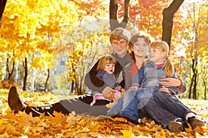 Family on autumn leaves