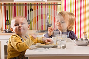 Family baby brother and sister play eat meal in toy kitchen