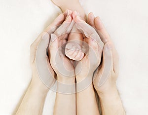 Family Baby hands, Newborn Kid hand into Mother Father Parents hands