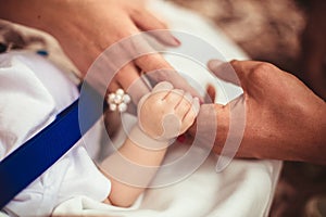 Family Baby Hands. Father and Mother Holding Newborn Kid. Child Hand Closeup into Parents