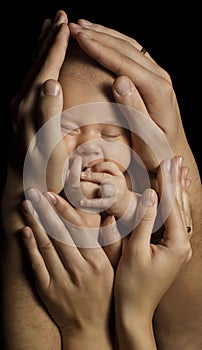 Family and Baby. New Born Kid in Parents Hands. Child Birth and Care Concept. Newborn Sleeping