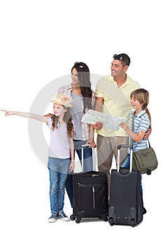 Family with bags looking away while girl pointing