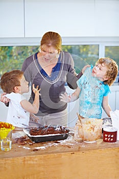 Family, baking and a mother scolding her children for the mess in a home kitchen with naughty boys. Food, cake or