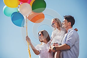 Family with balloons outdoors