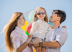 Family with balloons outdoors