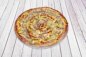 Family barbecue pizza with sauce, sliced green peppers, minced meat and lots of mozzarella cheese