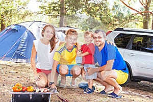 Family barbecue vacation. Happy family has picnic (bbq).