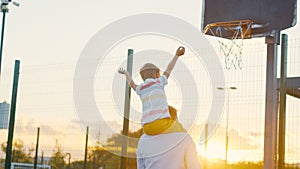 Family on the basketball court at sunset