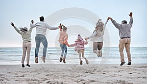 Family at the beach, adventure and jump, generations love and care while holding hands and fun by the ocean. Big family