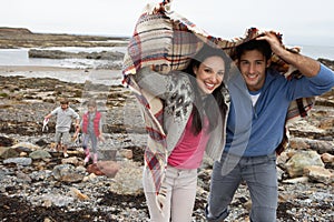 Family on beach with blankets photo