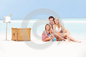 Family On Beach With Luxury Champagne Picnic