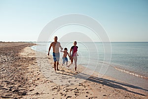 Family on the beach at sunset