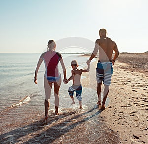 Family on the beach at sunset