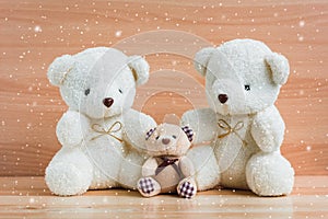 Family bears and snow on a wooden background.