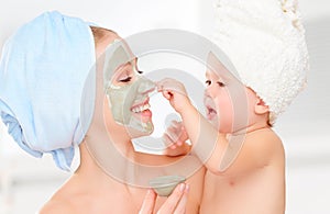 Family beauty treatment in bathroom. mother and daughter baby g