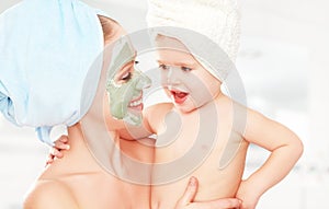 Family beauty treatment in bathroom. mother and daughter baby girl make mask for face skin