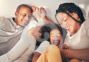 Family, bed and laughing in morning in happy home while playing, tickle or bonding with love. African woman, man and