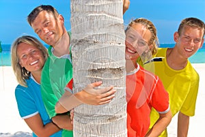 Family behind palm tree