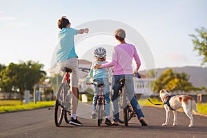 Family on bicycle. Parents and kid ride bike