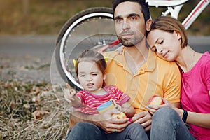 Family with a bicycle in a summer park