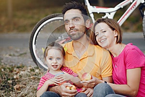 Family with a bicycle in a summer park